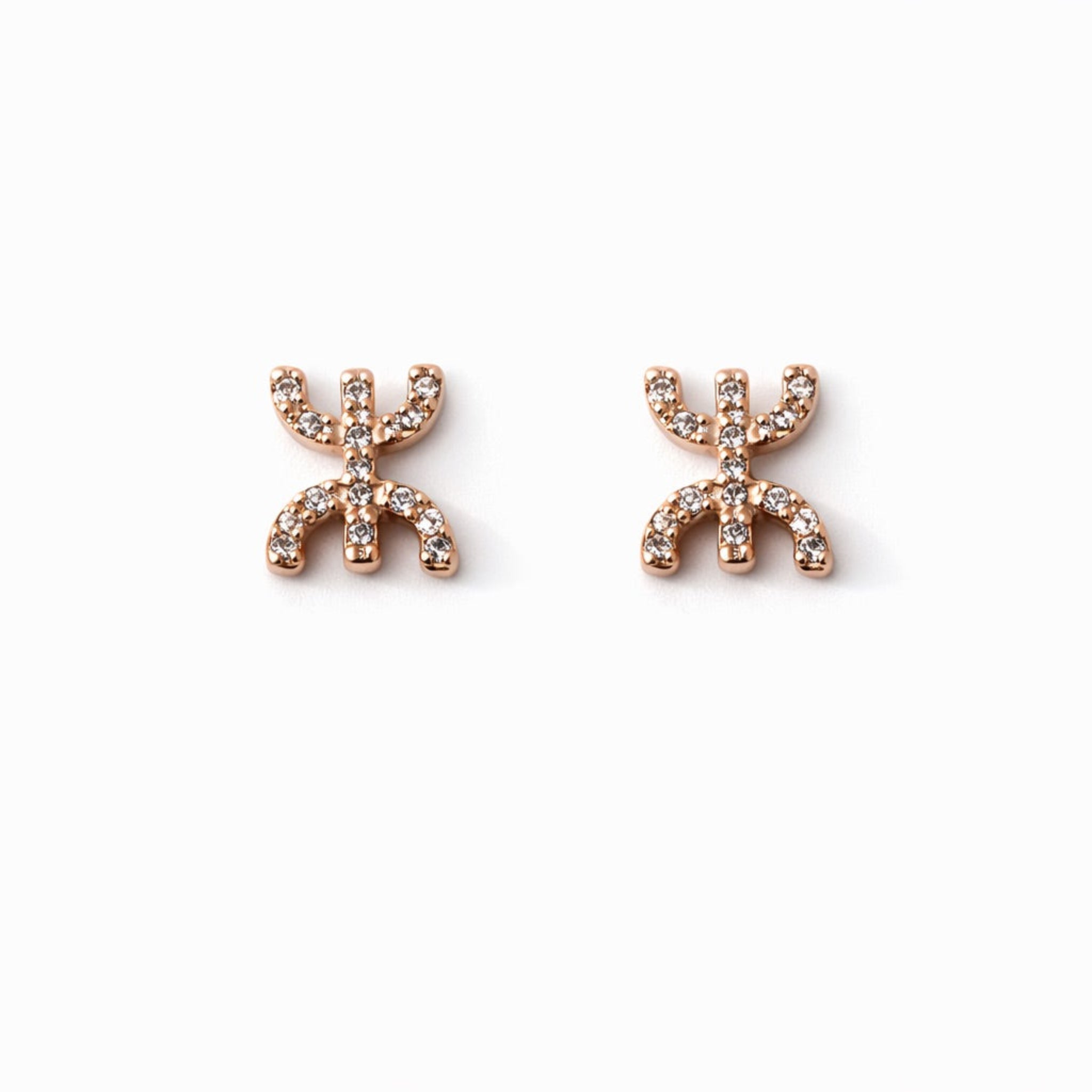 Tafat stud earrings featuring the Amazigh Yaz symbol in gold and silver finishes.