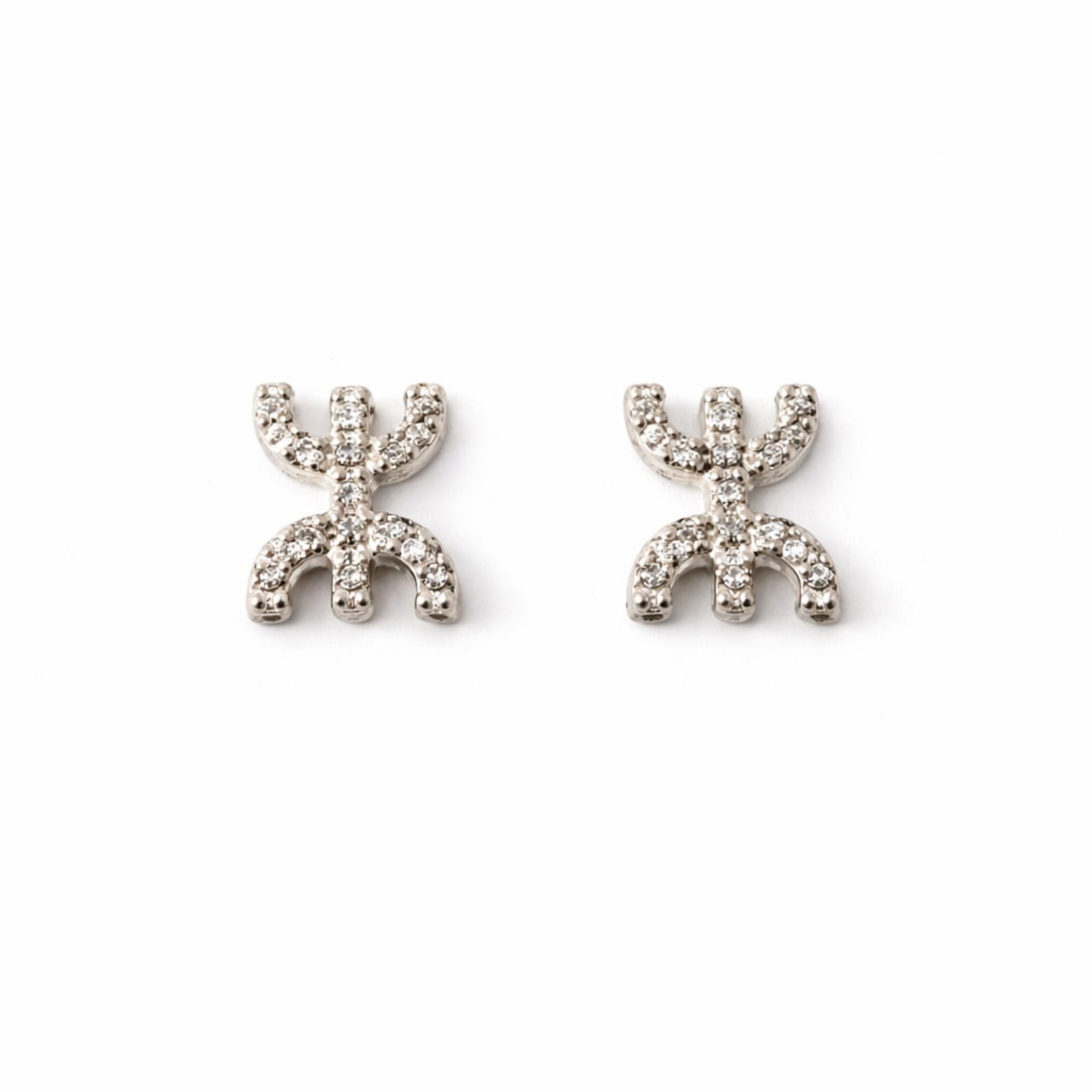 Tafat stud earrings featuring the Amazigh Yaz symbol in gold and silver finishes.