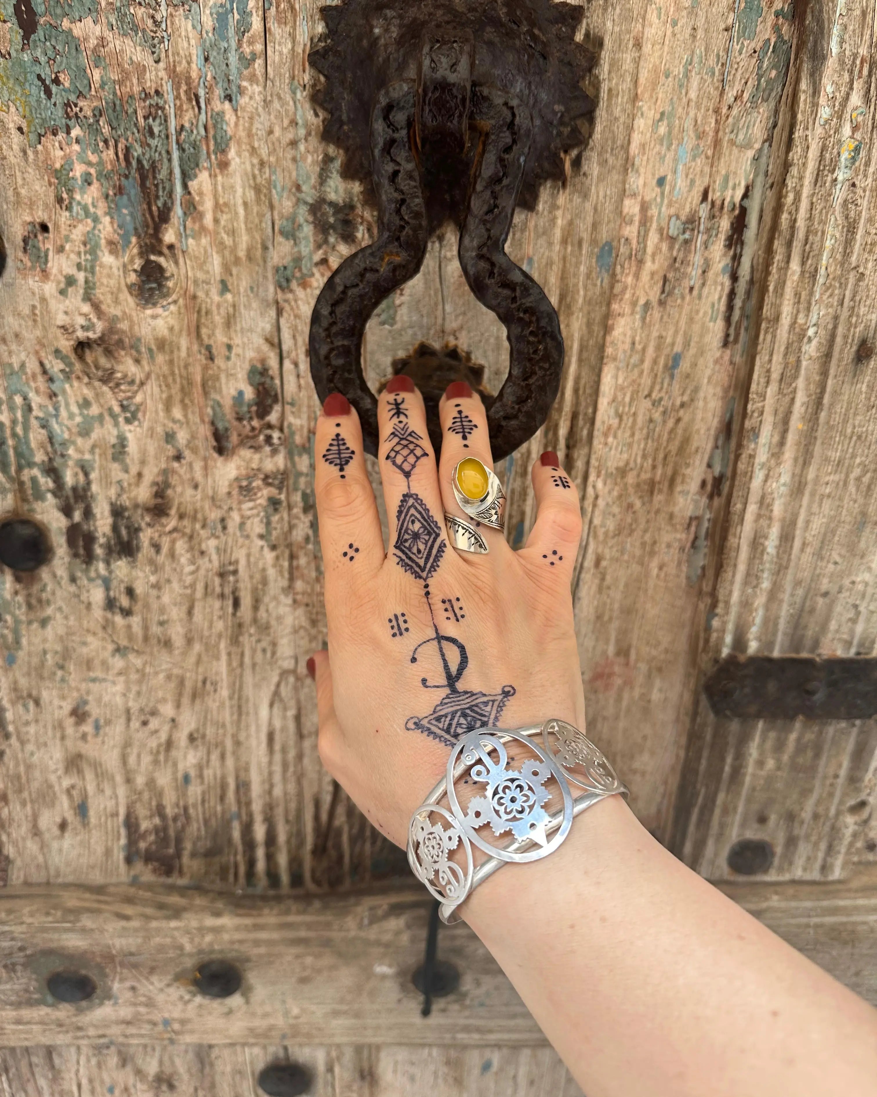 Tasaft handmade silver ring with a spiral design and central natural gemstone on an adjustable band.