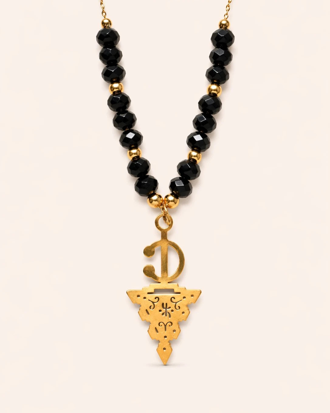 Maisa Amazigh-inspired statement necklace with red beads and a silver-toned fibula pendant on stainless steel.