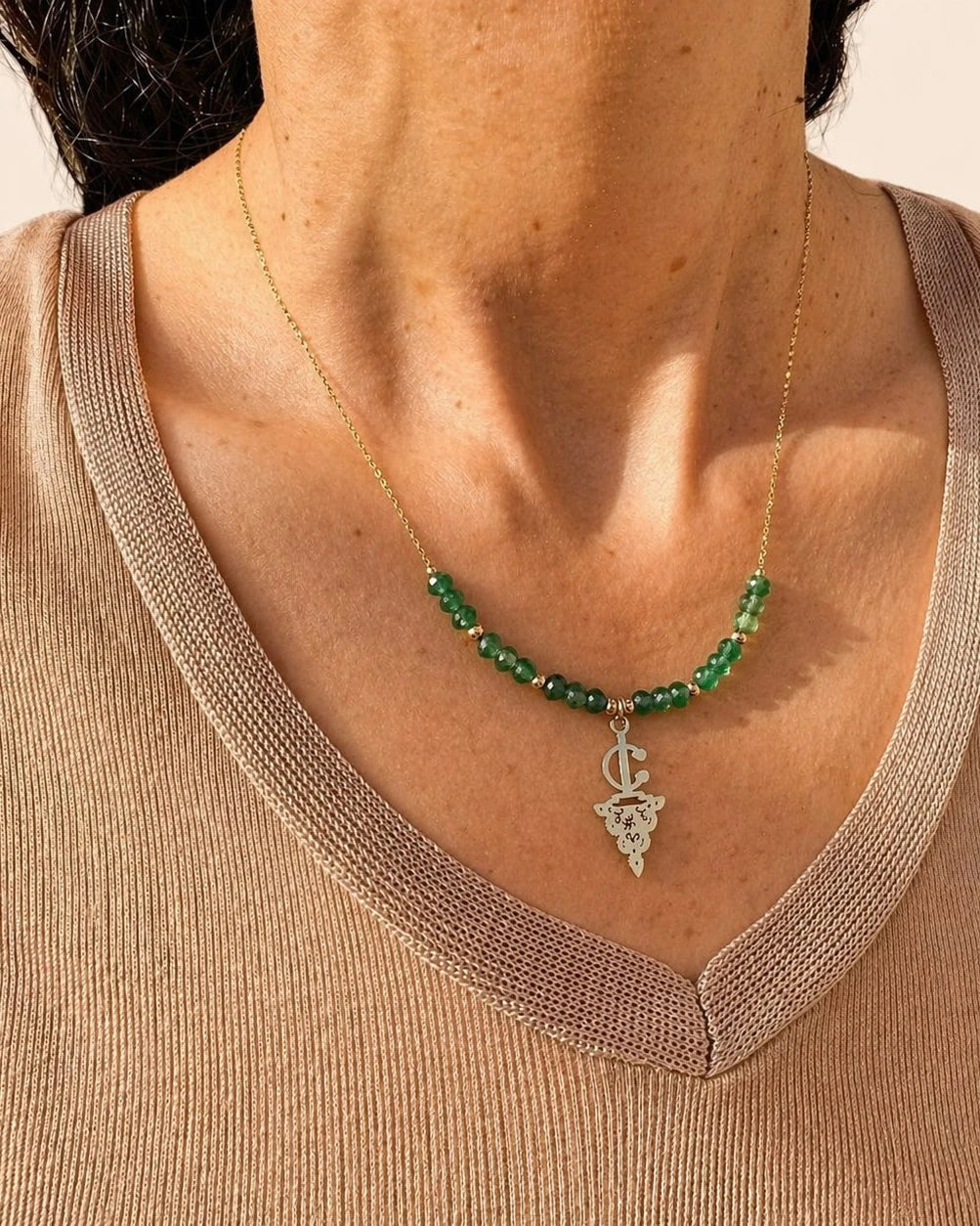 Maisa Amazigh-inspired statement necklace with red beads and a silver-toned fibula pendant on stainless steel.