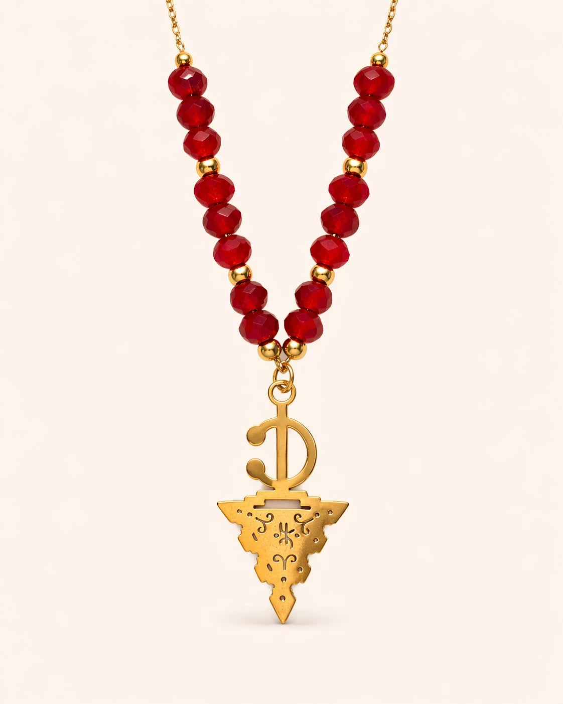 Maisa Amazigh-inspired statement necklace with red beads and a silver-toned fibula pendant on stainless steel.