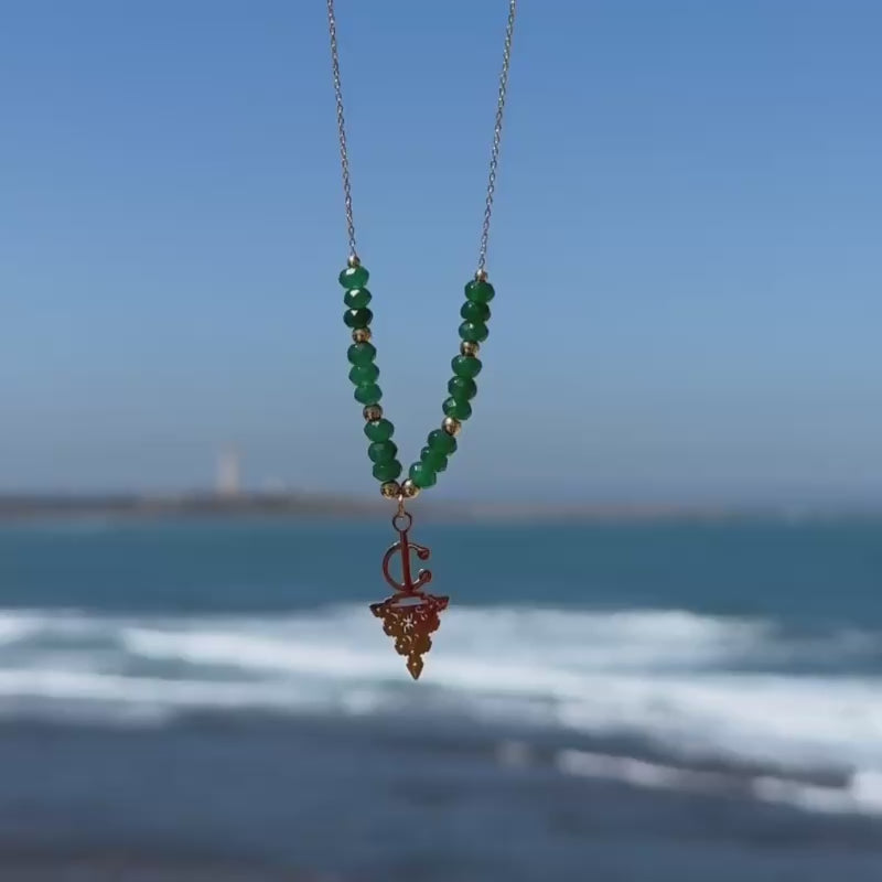 Maisa Amazigh-inspired statement necklace with red beads and a silver-toned fibula pendant on stainless steel.