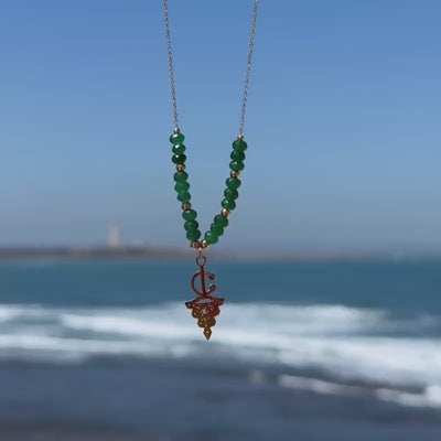 Maisa Amazigh-inspired statement necklace with red beads and a silver-toned fibula pendant on stainless steel.